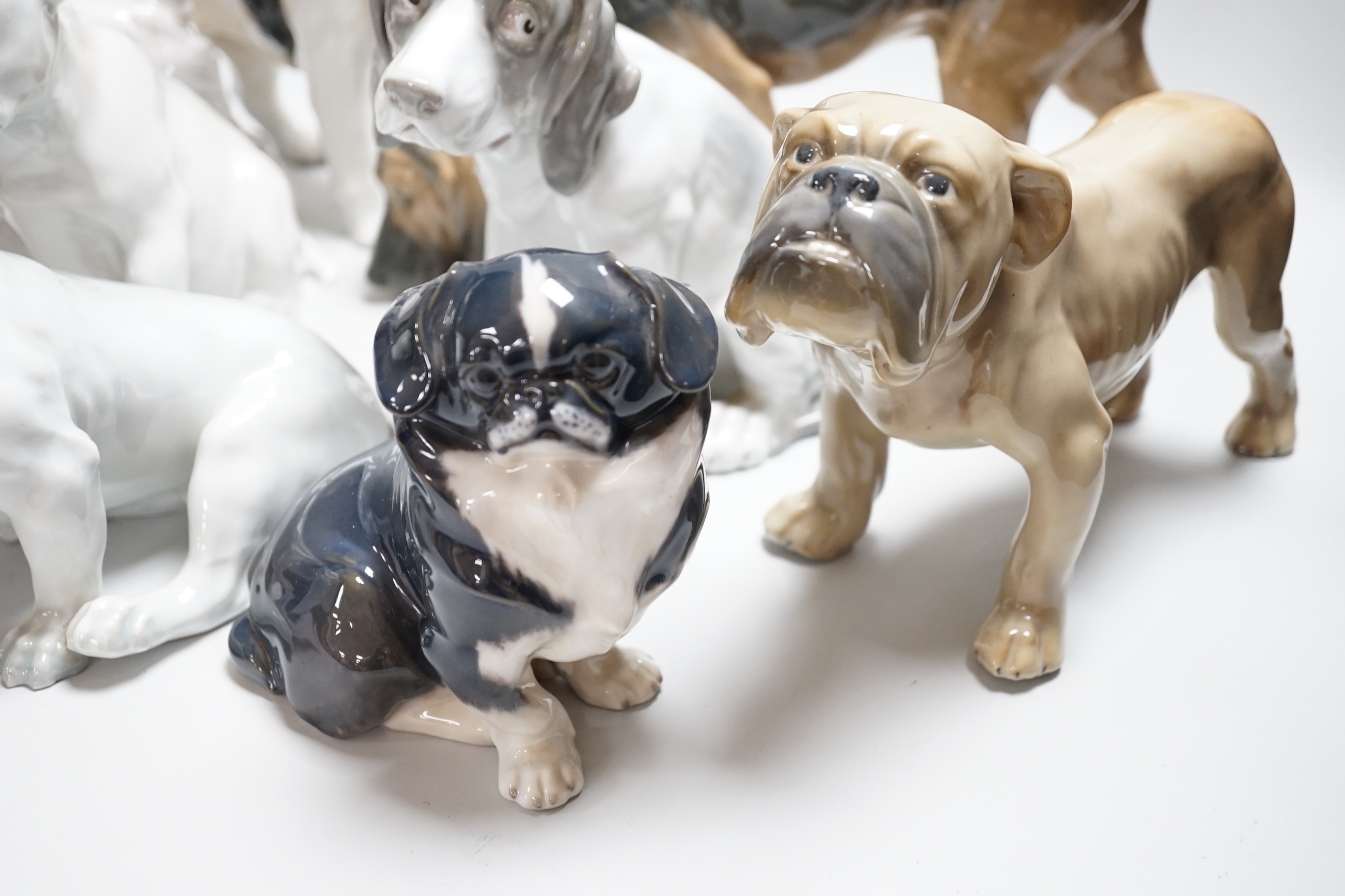Nine models of dogs; Royal Copenhagen, B&G and Rosenthal etc including terriers, bulldogs, King Charles spaniel, etc, the largest 30cm wide